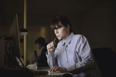 Young businesswoman using computer while working at work place