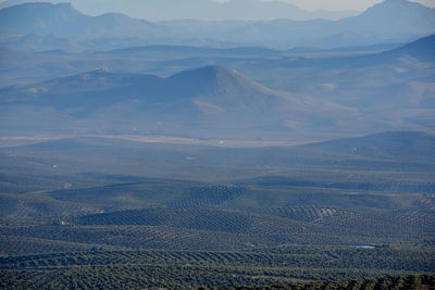 High angle view of land and mountains against sky