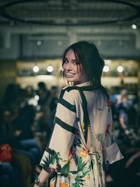 Young woman smiling while standing outdoors