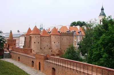 Buildings in city against clear sky