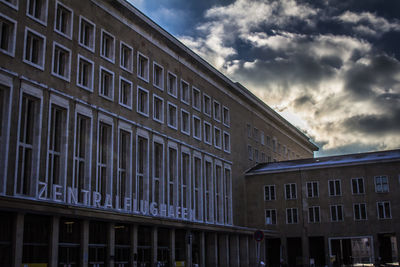 Low angle view of building against cloudy sky