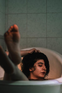 Young woman looking at camera at home