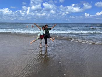 Two senior women enjoying on the beach of bali, indonesia