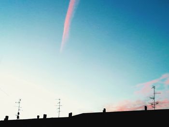 Low angle view of silhouette building against sky