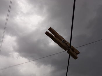 Low angle view of telephone pole against sky