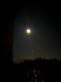 Low angle view of moon against sky at night