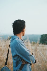 Side view of man standing in field