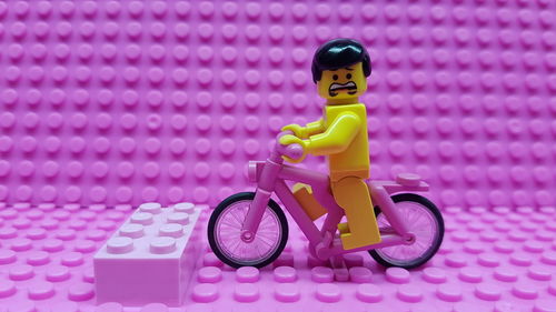 Boy with pink toy bicycle