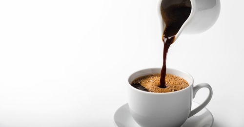 Close-up of coffee cup over white background