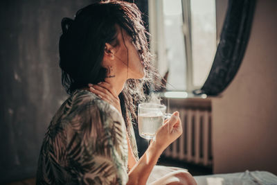 Portrait of woman drinking water