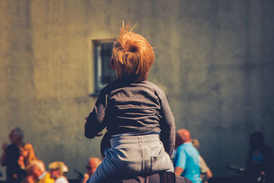 Rear view of woman standing in city