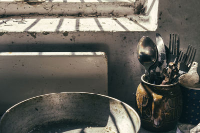 Cutlery in container by window