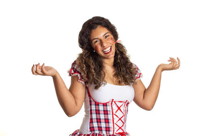 Smiling young woman standing against white background