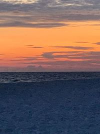 Scenic view of sea against orange sky