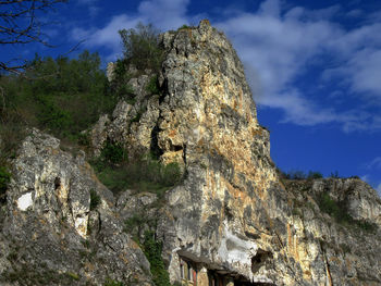 Low angle view of rock formations against sky