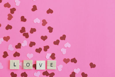 Close-up of heart shape against pink background