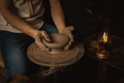 Man makes plate in pottery workshop, clay product, authentic atmosphere, background, footage. 