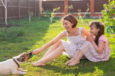 Girl and woman standing by plants