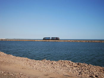 Scenic view of sea against clear blue sky