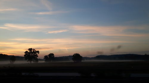 Scenic view of silhouette landscape against sky at sunset