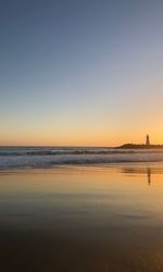 Scenic view of sea against clear sky during sunset