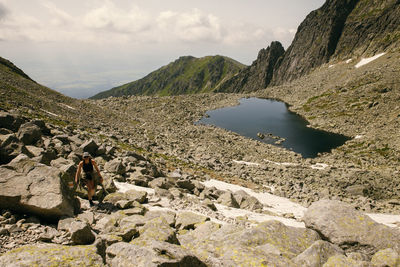 Scenic view of sea and mountains against sky