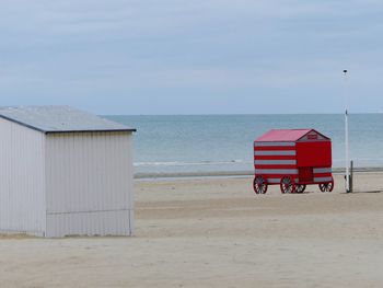 Lifeguard hut on beach against sky