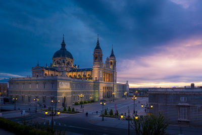 Picturesque almudena cathedral with ornamental towers on background of sunset sky in madrid