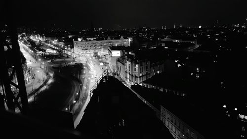 Illuminated cityscape against sky at night