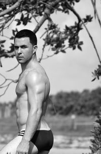 Woman standing on tree trunk