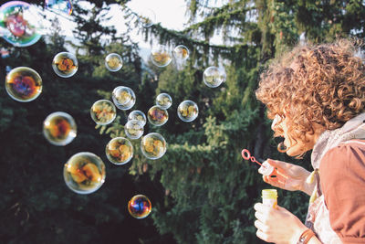 Woman blowing bubbles from wand