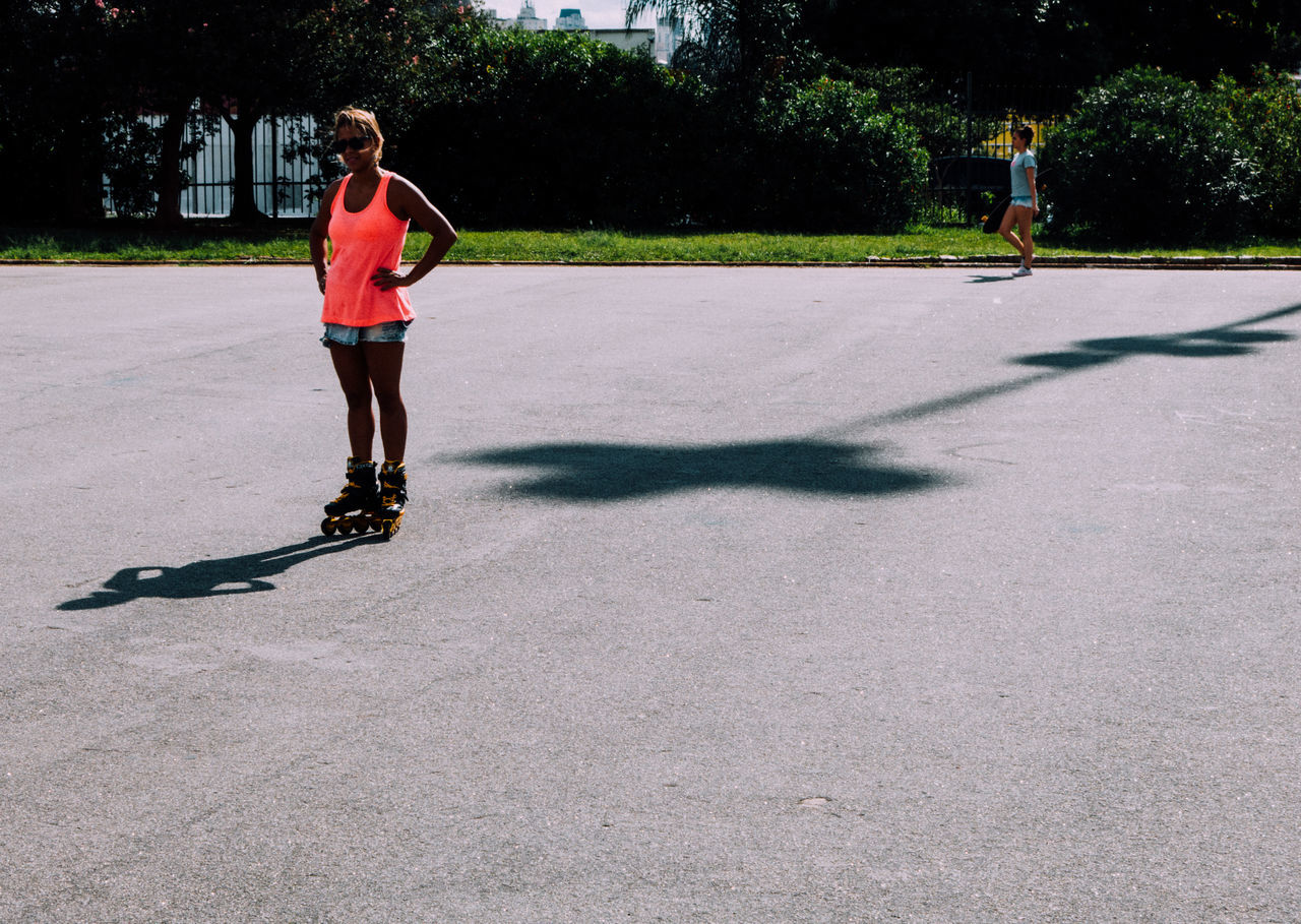 lifestyles, full length, leisure activity, casual clothing, childhood, elementary age, person, girls, street, standing, walking, sunlight, playing, boys, front view, fun, shadow, running