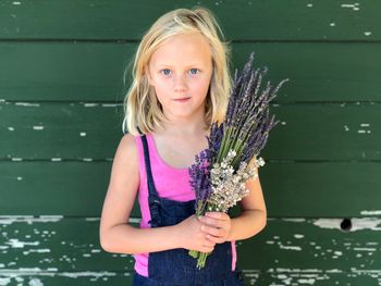 Portrait of happy girl holding purple outdoors