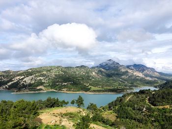 Scenic view of lake and mountains against sky