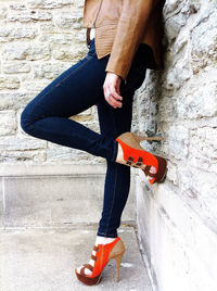 Full length of young woman standing by railing