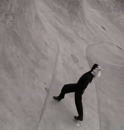 Woman in black dancing in the concrete pull