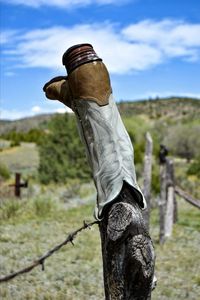 Cemetery fence adorned with boots