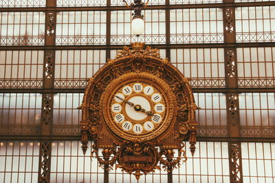 Low angle view of clock on wall