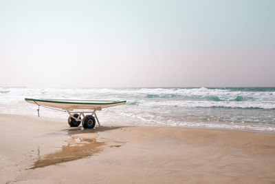 Paddleboard on rack against scenic view of sea