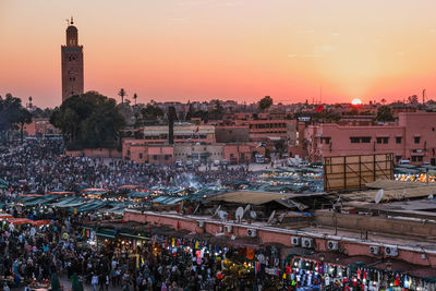 Crowd in city at sunset