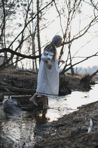 Woman in ukrainian folk dress walking on water scenic photography