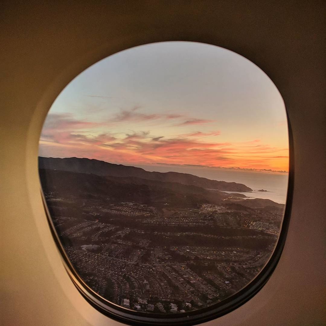 LANDSCAPE SEEN THROUGH WINDOW DURING SUNSET