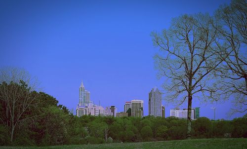 Tall buildings against clear blue sky