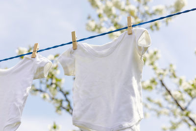Close-up of clothes hanging on chainlink fence