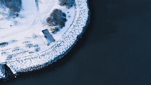 High angle view of sea by frozen promenade