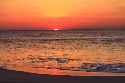 Scenic view of sea against romantic sky at sunset