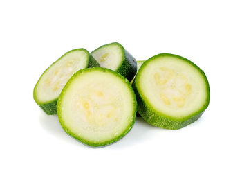 Close-up of green fruits against white background