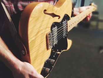 Close-up of man playing guitar