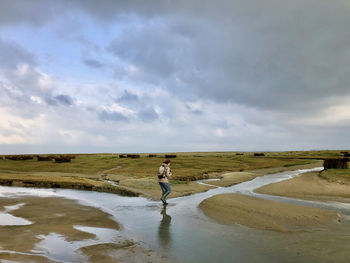 Man standing on beach against sky