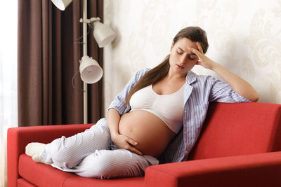 Side view of woman exercising at home